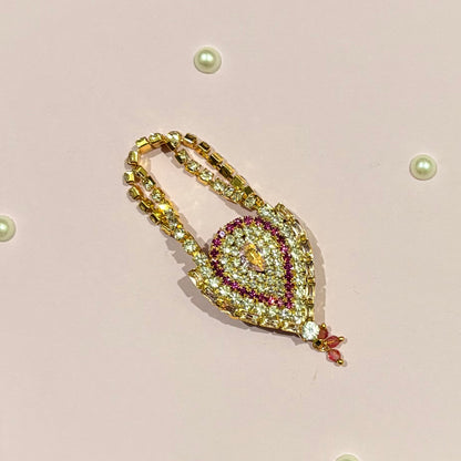 Pink AD Drop Shaped Purse, a miniature gold-tone American Diamond teardrop purse for deity shringar and pooja decoration