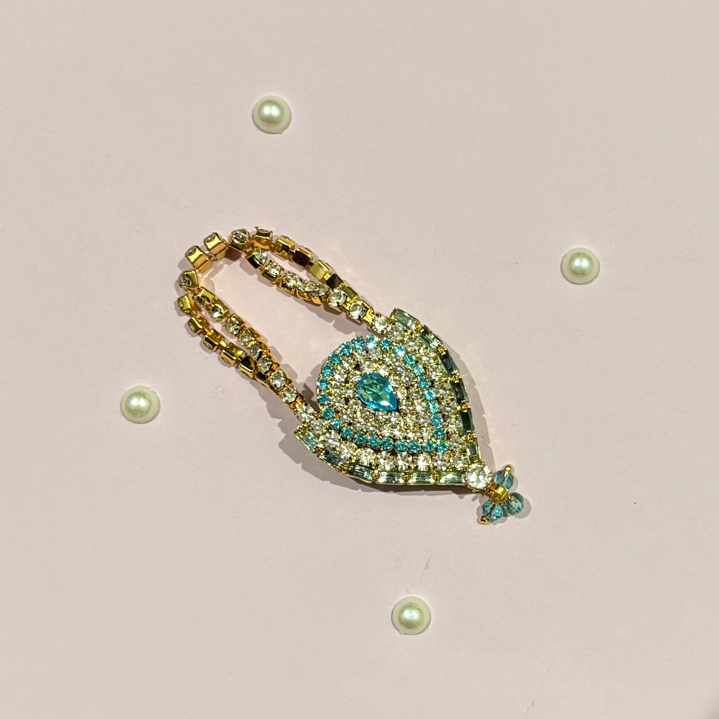 Sky blue AD Drop Shaped Purse, a miniature stone-studded teardrop purse to adorn deity idols like Laddu Gopal and Radha Rani
