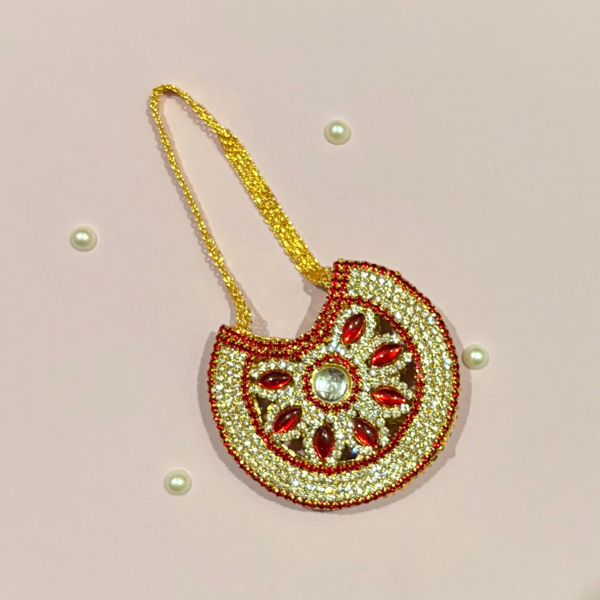 Red AD Moon Shaped Purse (Big), a gold-tone stone-studded crescent purse to adorn deity idols like Radha Rani and Laddu Gopal