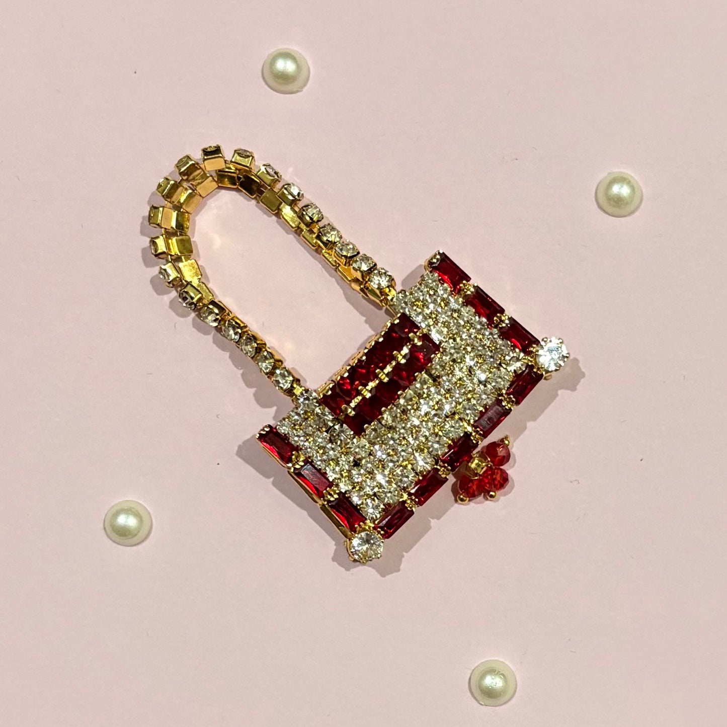 Red AD Rectangular Purse, a miniature gold-tone stone-studded purse to adorn deity idols like Radha Rani and Laddu Gopal