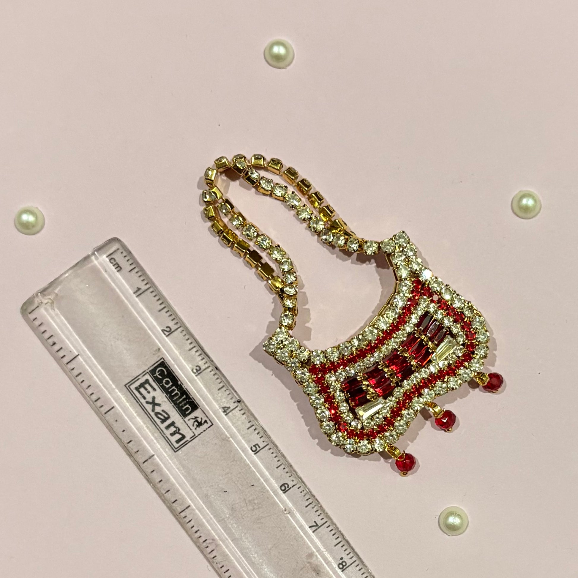 Butterfly AD Purse for deity shringar, a miniature stone-studded purse available in red, gold, dark blue, pink, sky blue and green