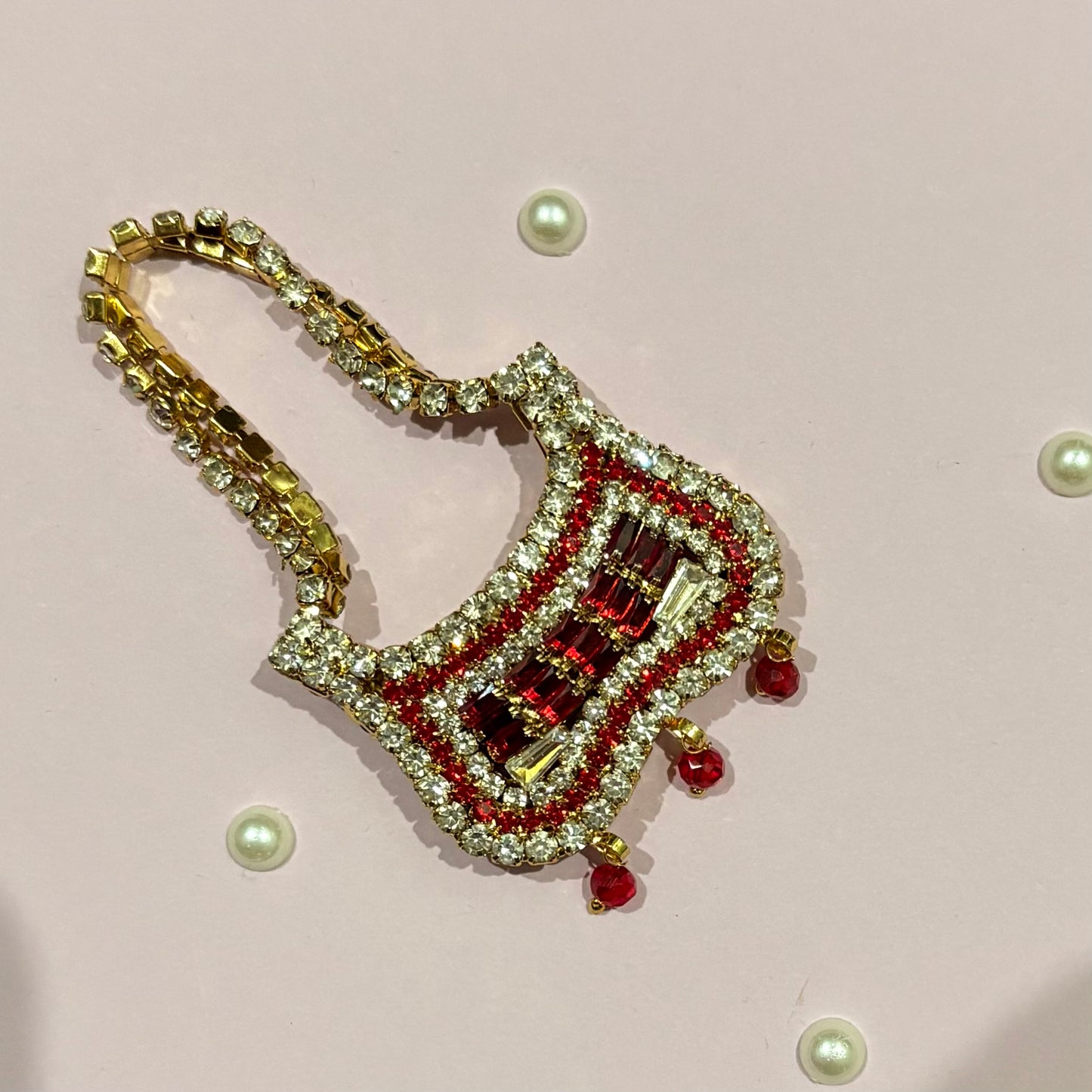 Red Butterfly AD Purse, a miniature gold-tone stone-studded purse to adorn deity idols like Radha Rani and Laddu Gopal