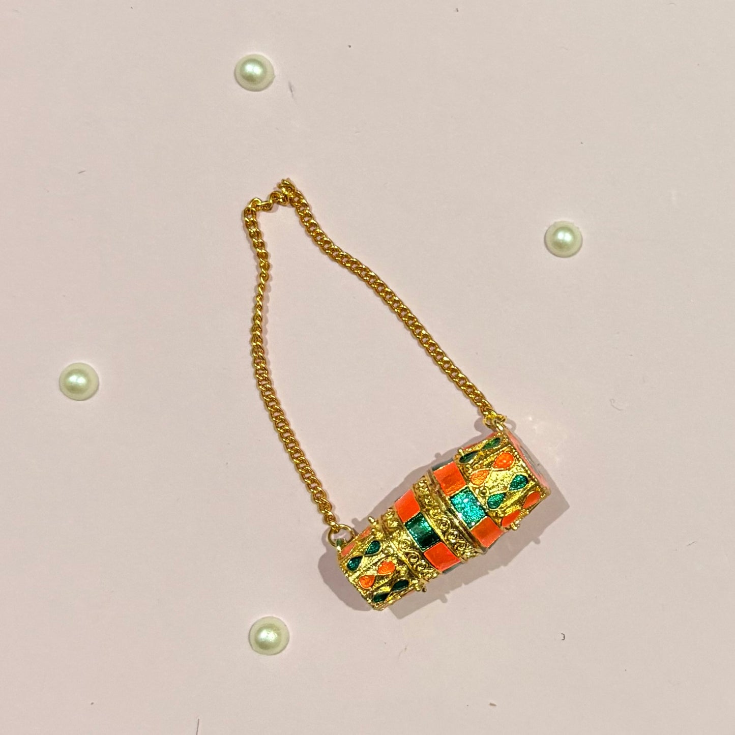 Miniature gold-tone Dholak with colourful enamel work and hanging chain, a handcrafted shringar accessory to adorn deity idols like Radha Rani and Laddu Gopal