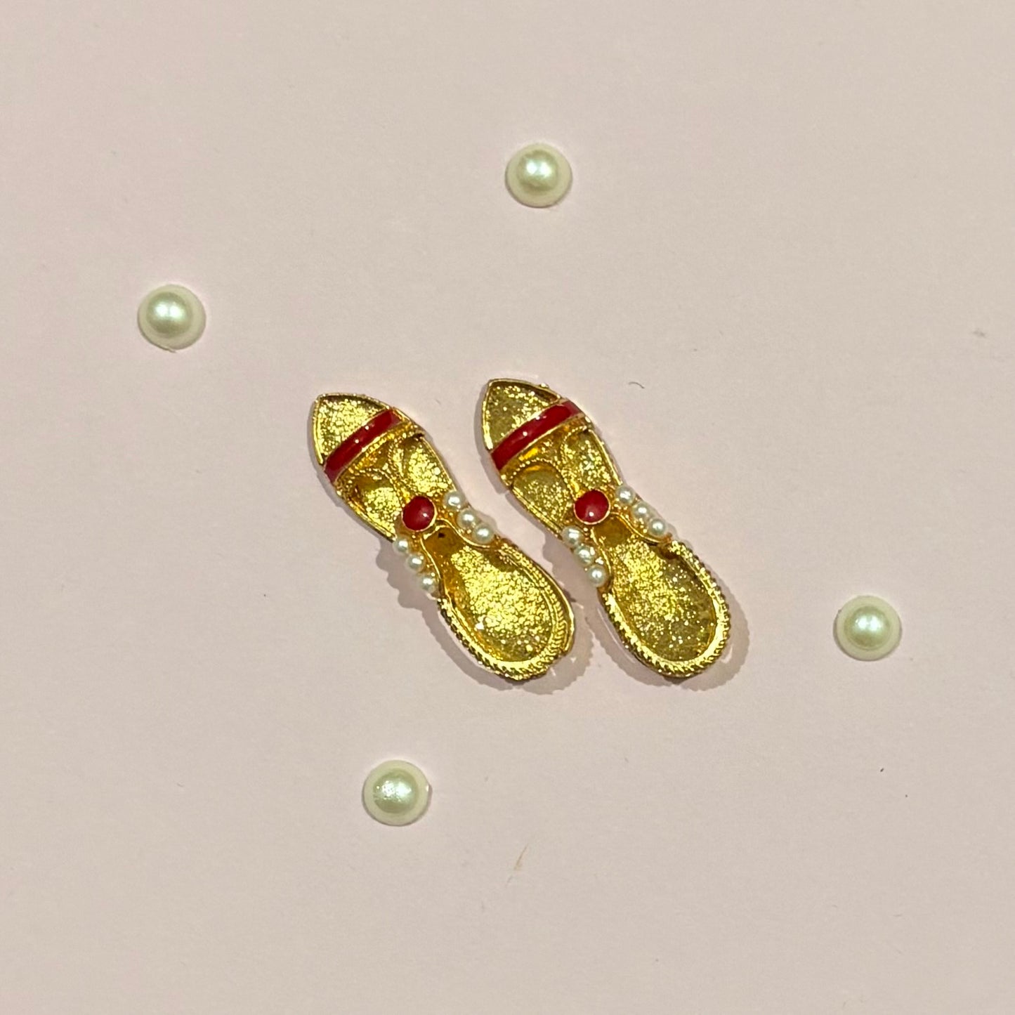 Miniature gold-tone Sandal (charan paduka) for deity seva, a handcrafted pair representing the holy feet of idols like Radha Rani and Laddu Gopal