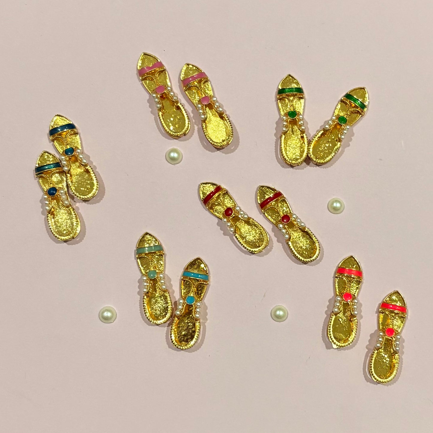 Close-up of the miniature Sandal (charan paduka) with intricate detailing, a sacred accessory for deity shringar and daily worship